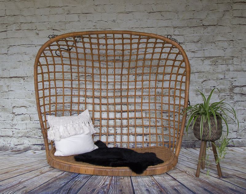 Hanging Rattan Egg Chairs Swinging From Chains
